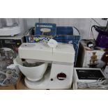 A Kenwood Chef mixer with attachments