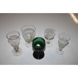 An antique green glass drinking glass and four oth