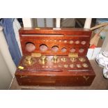 A cased set of brass apothecary weights