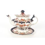 A Victorian Staffordshire teapot and stand by Thom