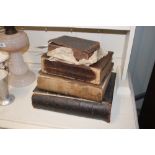 An antique leather bound Bible and other books