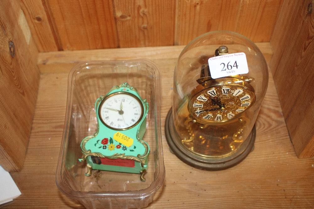 An anniversary clock contained in glass dome; and