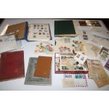 A box of various stamp albums and loose stamps