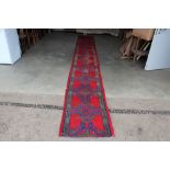 An approx. 18'6" x 2'4" red and blue patterned run