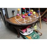 A circular coffee table raised on ball and claw supports