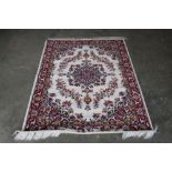 An approx. 4'7" x 4' red patterned rug