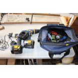 A tool bag and contents and two cordless drills an
