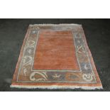 An approx. 6' x 4' pink and blue patterned rug