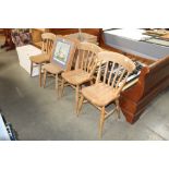 A set of four pine flat back dining chairs