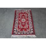 An approx. 4'3" x 2' Kamar red patterned rug