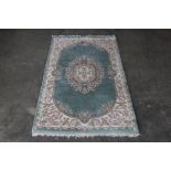 An approx. 5'2" x 3' blue floral patterned rug