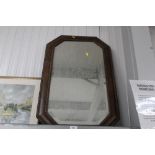 An oak framed octagonal bevelled edge wall mirror