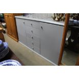 A modern grey sideboard fitted five central drawer