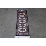 An approx. 2'8" x 1' Mori Jalda rug