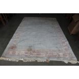 An approx. 10'6" x 6'7" blue patterned rug