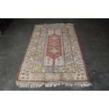 An approx. 6'9" x 4' blue and red patterned rug