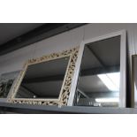 A modern white wall mirror; and a large ornate framed bevelled edge wall mirror