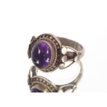 A silver and amethyst ring