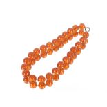 An antique amber necklace, double knotted, length 36cm