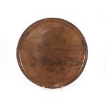 An 18th Century circular walnut tray, 33cm dia.