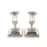 A pair of late Victorian silver dwarf candlesticks with beaded and leaf decoration, Sheffield 1896,