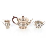 A George V silver three piece tea set, with reeded borders and foliate motifs, Sheffield 1924,