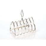 An Edwardian silver six division toast rack, Sheffield 1904