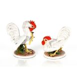 A pair of Italian porcelain figures, depicting fighting cockerels