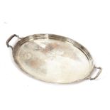 A George V oval silver tea tray, with acanthus leaf decorated reeded handles within a stepped