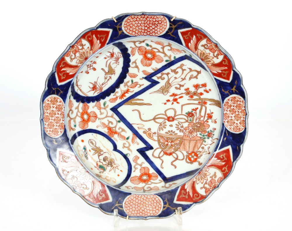 A pair of Imari scallop bordered chargers, decorated flowers and artefacts, heightened in gilt, 27. - Image 3 of 3