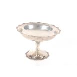 A silver pedestal dish, having shaped reeded border, London 1919, 11oz