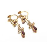 A pair of gold and ruby ear-rings with screw fittings