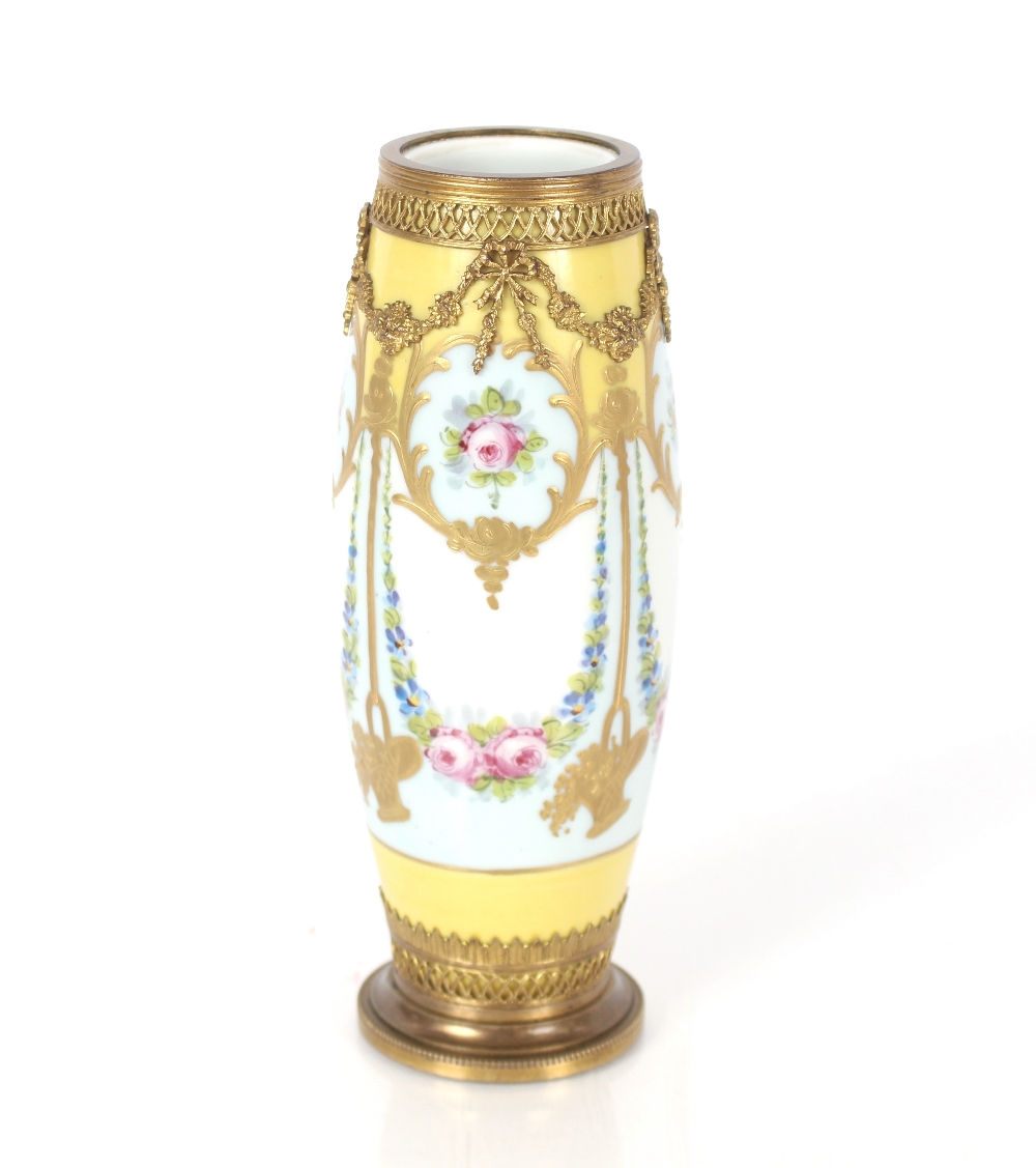 A late 19th Century French Sevres type porcelain vase, painted with swags of flowers, gilt metal