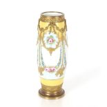A late 19th Century French Sevres type porcelain vase, painted with swags of flowers, gilt metal
