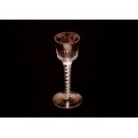 An antique drinking glass, with bell shaped bowl on spiral cotton twist stem and spread foot, 15cm