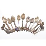 A small modern silver caddy spoon; a pair of Georgian silver sugar tongs; various silver spoons;