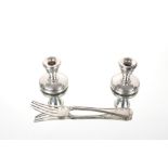 A pair of dwarf silver candlesticks; and a Victorian silver pickle fork, London 1876 (3)