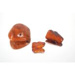 A large amber piece, weight 56gms and two other small pieces of amber