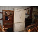 A painted pine cabinet with cupboard base