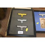 A framed and glazed set of three officers breast e