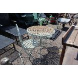 A metal garden table and two folding chairs