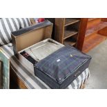 A suitcase and a box containing vintage clothing