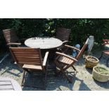 A folding slatted garden table and four hardwood f