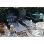 A pair of garden loungers and a table