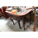 A mahogany demi lune table raised on ring turned s