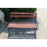 A metal and wooden slatted garden bench