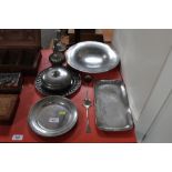 A collection of pewter dishes; pot and cover; a pa