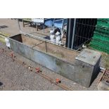 A large galvanised water trough approx. 8ft long