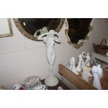 A white glazed statue of a naked girl marked Dilettante