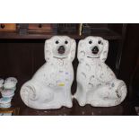 A pair of Staffordshire dogs with gilt heightened